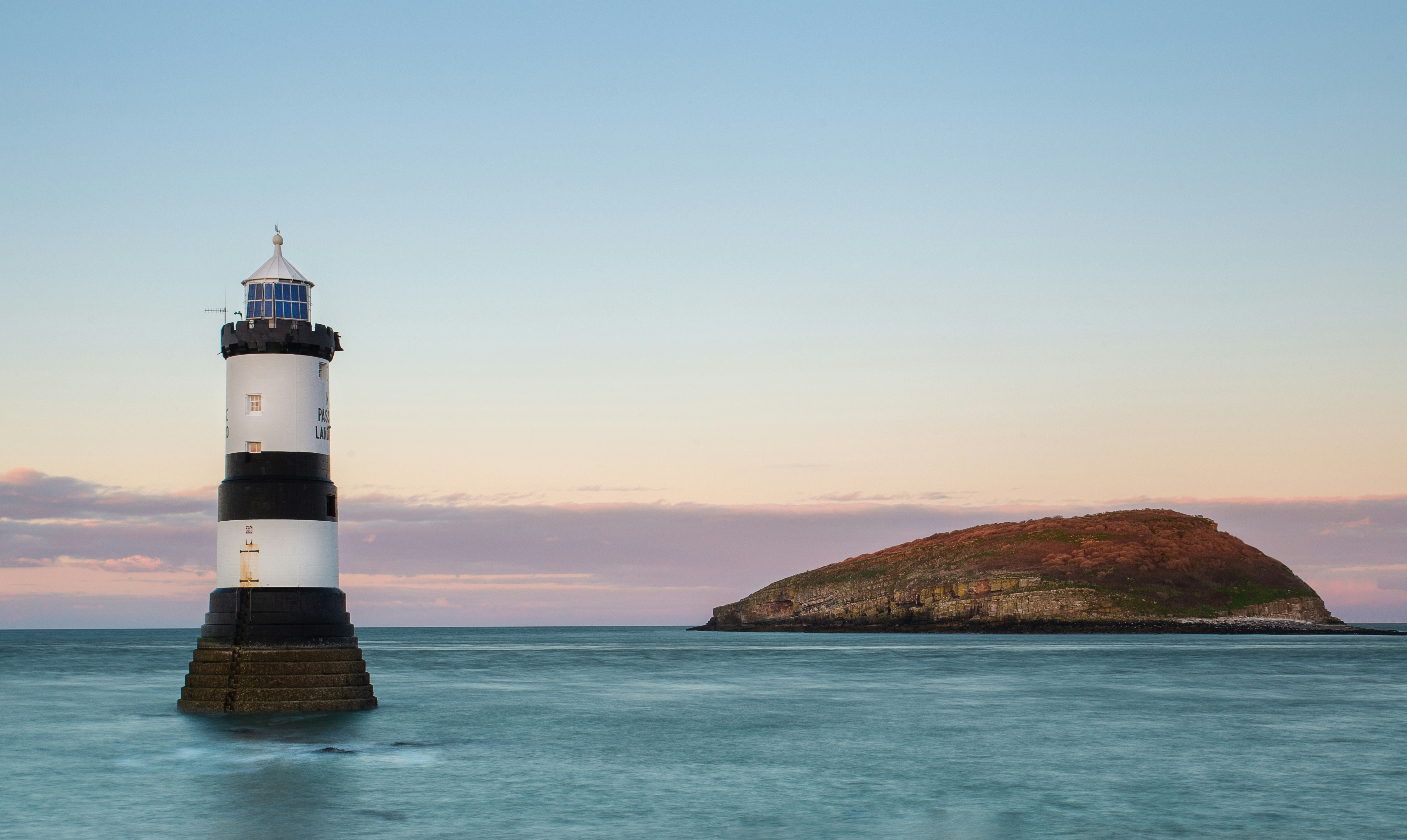 image of Penmon Lighthouse and Puffin Island off Anglesey Ynys Mon Wales UK